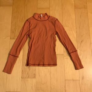 The Rickie Rust Orange Ribbed Mock Neck long sleeve top from Free People